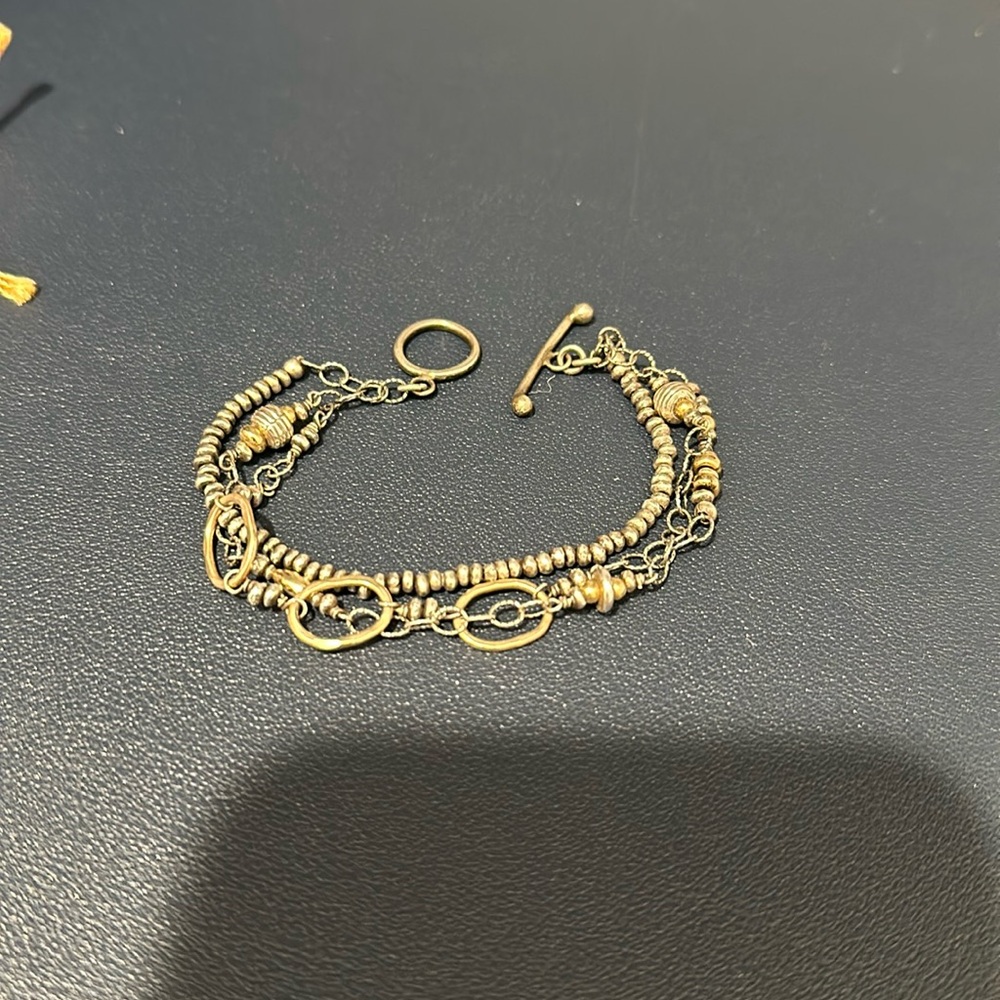 Island cowgirl 3 strand bracelet with toggle clasp. Two toned
